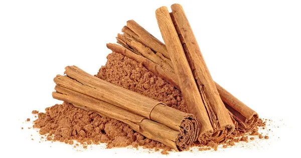 Ceylon cinnamon sticks with powder on a white background